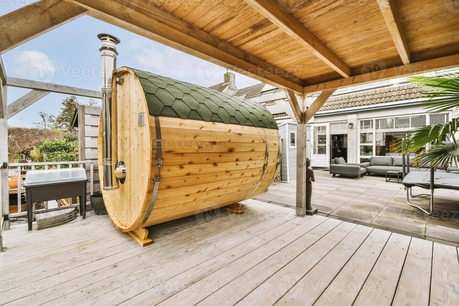 Outdoor cedar barrel sauna on a covered patio deck — installed by Cedar & Steam at a Vancouver-area home